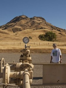 Dave Garcia, who has led the fight against fracking in Butte County, poses near a gas-well pump in the nearby Sutter Buttes, where many wells have undergone hydraulic fracturing.